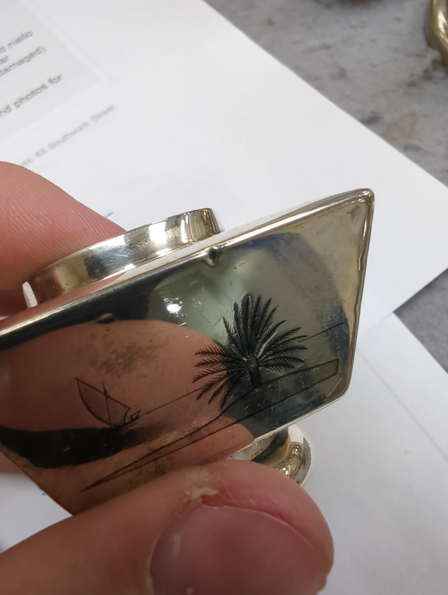 Thirteen assorted Iraq white metal and niello condiments, circular box, five similar napkin rings, a brooch and a pair of similar (damaged) candlesticks.